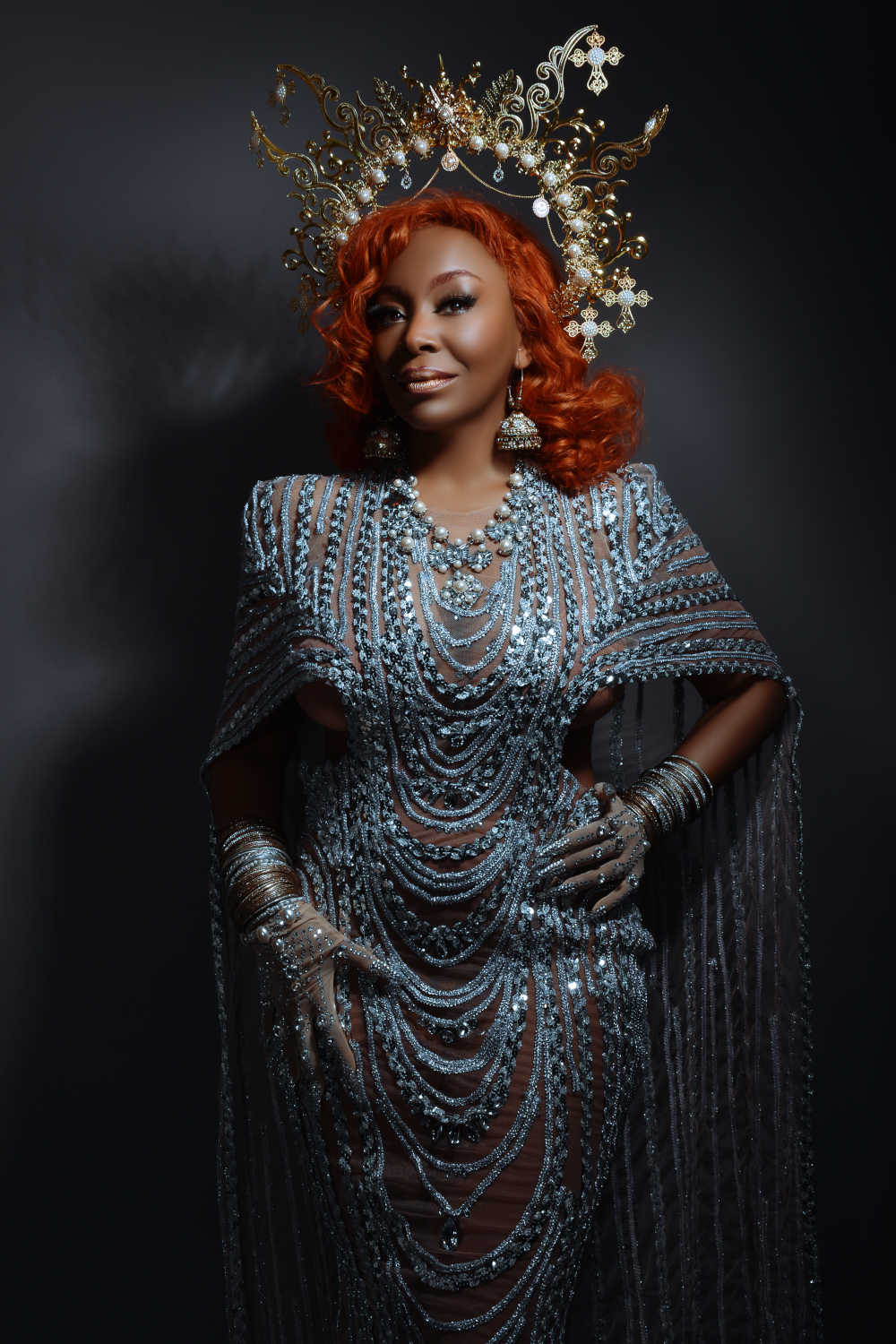 Image of Kele le Roc in a sparkling dress, gloves and golden headdress
